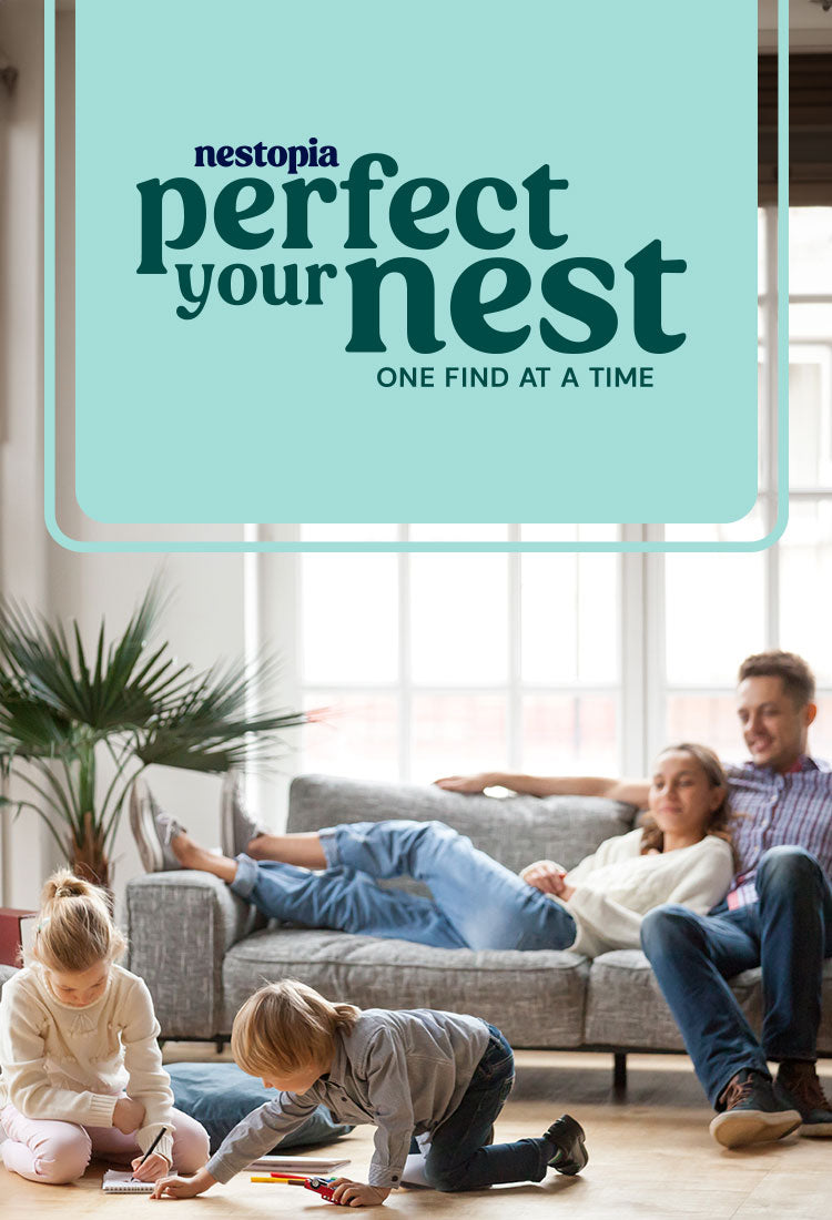 two children sitting on the floor with parents sitting on couch watching them